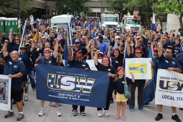 Crowd of Steelworkers marching with raised fists