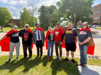 supporters in red capes